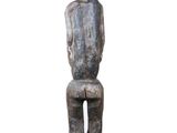 an image of a statue of a person sitting on a stool