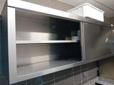 a stainless steel cabinet in the middle of a kitchen