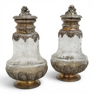 pair of silver and glass vases on pedestals on a white background