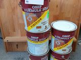 several cans of paint are stacked on top of each other on the floor