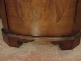 a wooden cabinet with a mirror on top of it