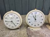 two clocks sitting next to each other on a table