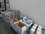 several boxes of toilet paper are sitting on the floor in a room