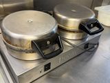 stainless steel counter top with two pans on top of it