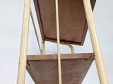 a chair that has a wooden seat on it