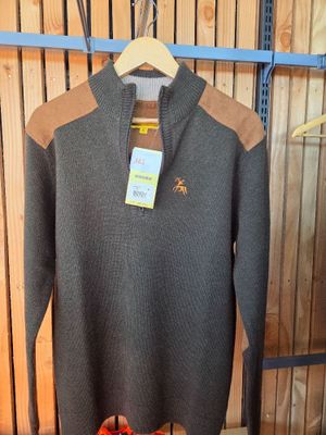 a sweater hanging on a rack in a store