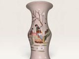 a small vase with a painting on it on a white surface