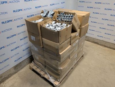a stack of boxes on a pallet in front of a wall
