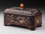 a wooden box with a orange on top of it