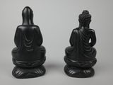 two black statues of buddhas sitting on top of each other