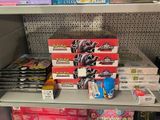 many boxes of candy on a shelf in a store