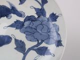 a blue and white plate with a picture of a mouse on it