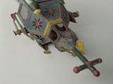 a toy helicopter that is sitting on a white surface