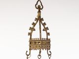 an old brass bell hanging from a chain on a white background