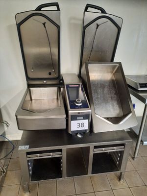 three stainless steel sinks on a table in a kitchen