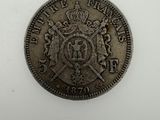 a silver coin with a crown on top of it