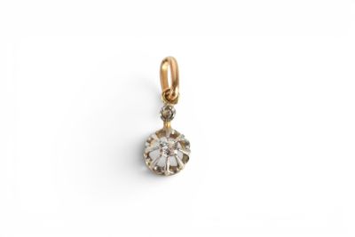 an image of a gold and diamond pendant on a white background