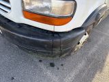 a white van that is parked on the side of the road
