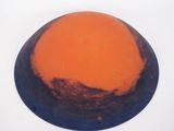 a picture of an orange and blue object on a white surface