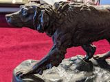 a statue of a dog that is standing on a rock
