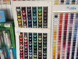 many different colors of paint on display in a store