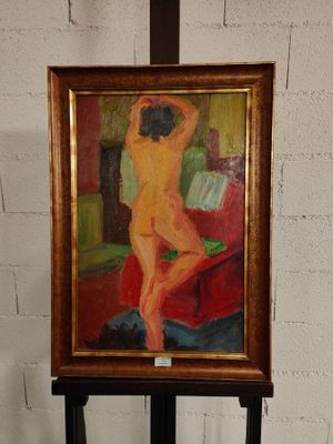 un tableau représentant une femme nue sur un chevalet