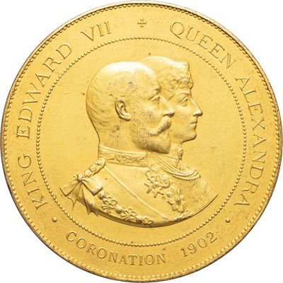 an image of a close up of a gold coin with a man and a woman on it