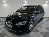 a picture of a black vw golf parked in a garage
