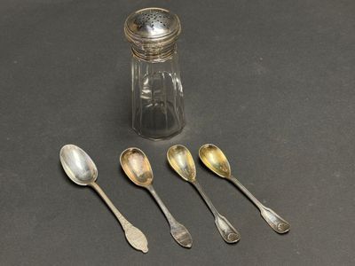five spoons and a salt shaker on a table