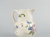 an image of a small white vase with flowers on it
