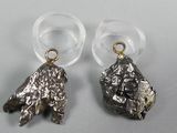 pair of silver and gold earrings on a white surface