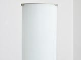 a white cylinder lamp that is sitting on a table