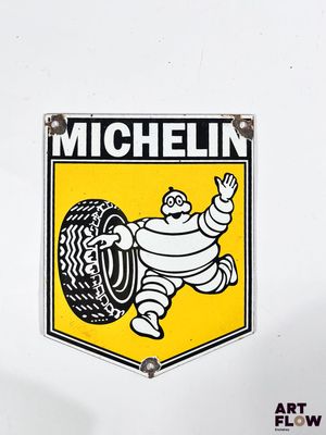 a michel tire sign on the side of a white truck