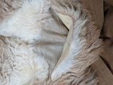 a cat that is laying down on a furry blanket