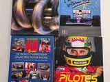 three books on a white table with a picture of a man in a racing car