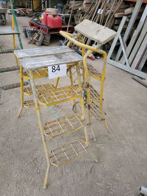 a yellow chair that is sitting in the middle of a lot