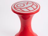 a red stool with a white and red design on it