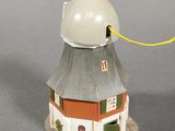 a small white and red building with a white dome on top of it