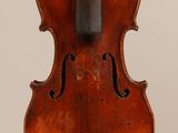 an old violin with a bow hanging from it ' s back