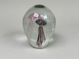 a glass vase with a jelly fish inside of it