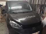 a van that is parked in the garage of a building
