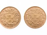two gold coins, one with a shield and the other with a crown