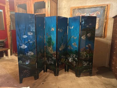a room divider with a fish scene painted on it