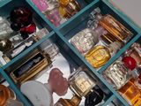 many different perfumes in a blue box on a table