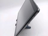 a tablet computer sitting on a stand on a white surface