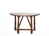 a wooden table with a circular top and wooden legs