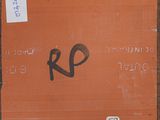 an orange box with writing on it sitting on a sidewalk