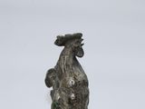statue of a rooster with a hat on its head