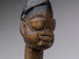 an image of a wooden sculpture of a man with a hat on his head