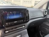 the interior of a car with a large screen in the center of it
